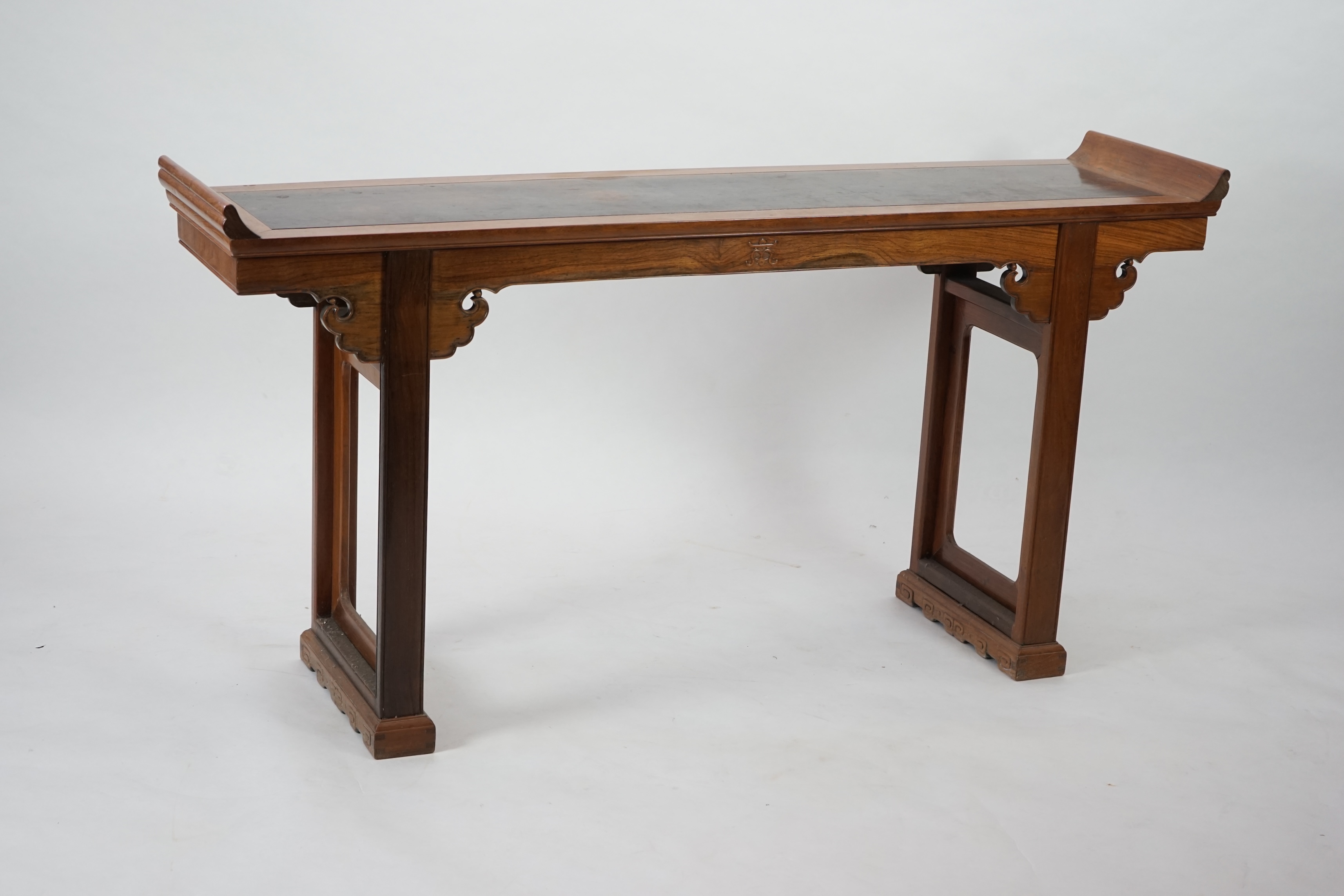 A Chinese padouk wood and jichimu altar table, the panelled rectangular top with scroll ends, on plain uprights headed by ruyi, 185cm wide, 94cm high. Condition - fair to good